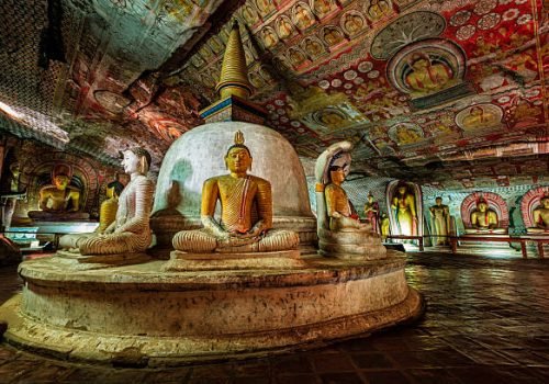 Buddha statue inside Dambulla cave temple, Sri Lanka. Dambulla cave temple also known as the Golden Temple of Dambulla is a World  Heritage Site in Sri Lanka, situated in the central part of the country. This site is situated 148 km east of Colombo and 72 km  north of Kandy. It is the largest and best-preserved cave temple complex in Sri Lanka. This temple complex dates back to the first century BCE. There are more than 80 documented caves in  the surrounding area. Major attractions are spread over 5 caves, which contain statues and paintings. These paintings and statues  are related to Lord Buddha and his life. There are total of 153 Buddha statues, 3 statues of Sri Lankan kings and 4 statues of  gods and goddesses.