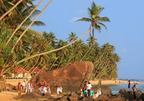 Unawatuna, Sri Lanka - January 1, 2011: People taking part in traditional wedding ceremony on a beach, Unawatuna, Sri Lanka